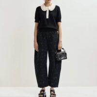 ESSENTIEL ANTWERP Polo en maille fine noir et blanc cassé à volants et perles Boutique rive gauche Belfort